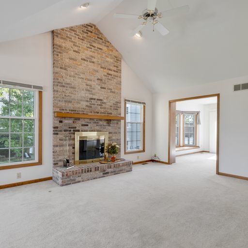 2600 Miller Road Geneva, IL 60134 - Photo 3 of 27 an empty room with fireplace and windows