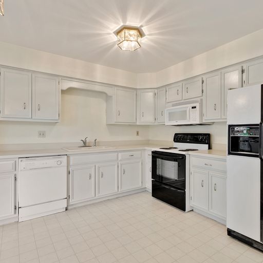 2600 Miller Road Geneva, IL 60134 - Photo 6 of 27 a kitchen with granite countertop white cabinets white stainless steel appliances with a sink and dishwasher