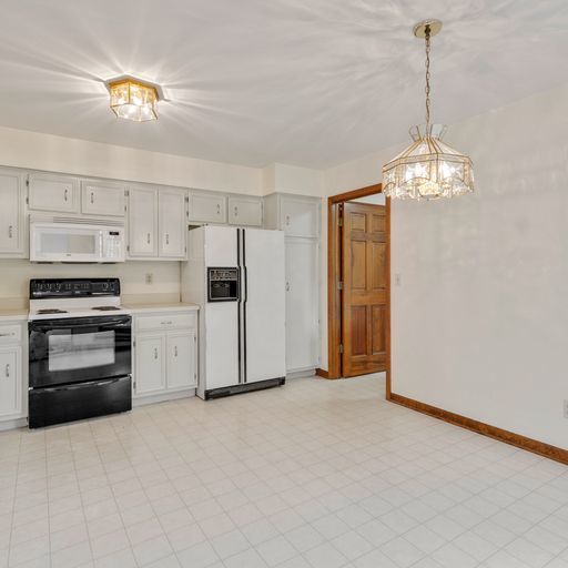 2600 Miller Road Geneva, IL 60134 - Photo 7 of 27 a kitchen with a refrigerator and a stove top oven