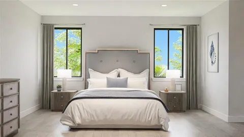 a bed sitting in a bedroom next to a window