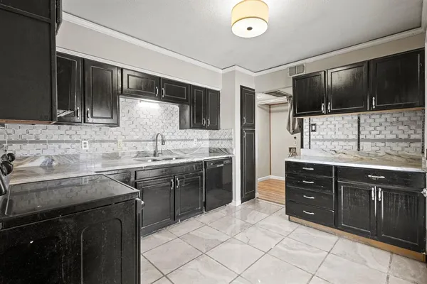 a kitchen with a sink stove and microwave