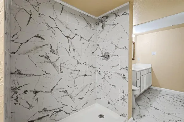 a bathroom with a bathtub and shower