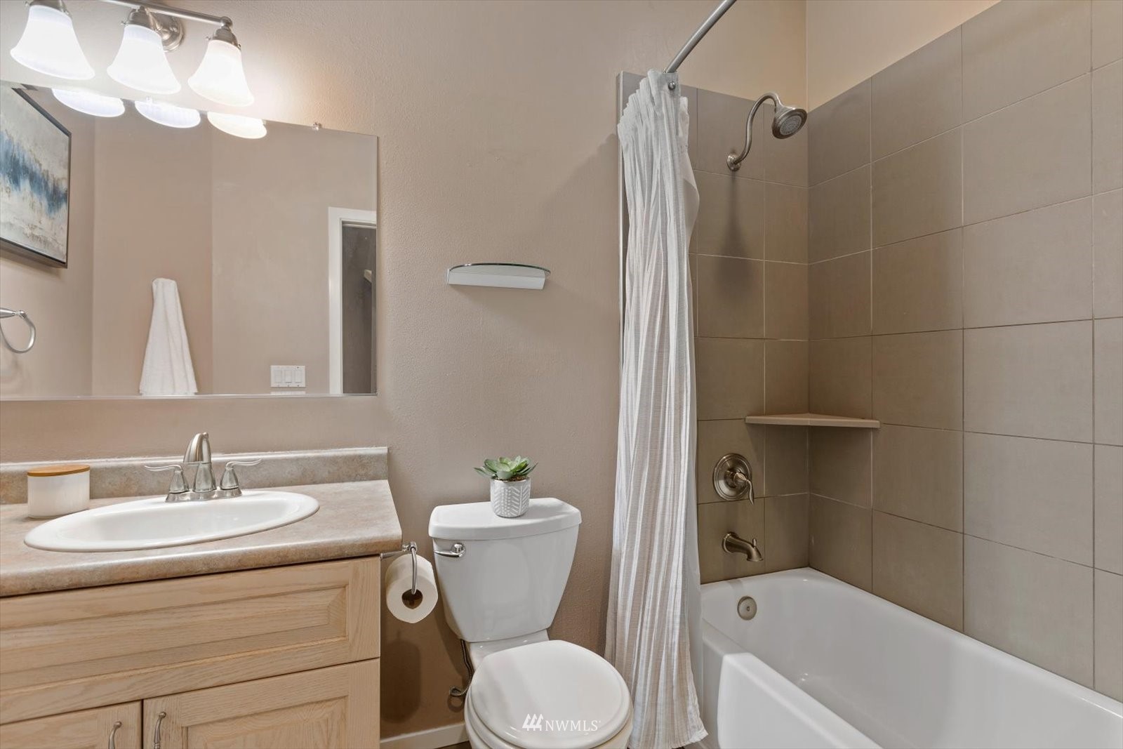 13629 3rd Drive Southeast Everett, WA 98208 - Photo 23 of 40 a bathroom with a sink a mirror a toilet and shower