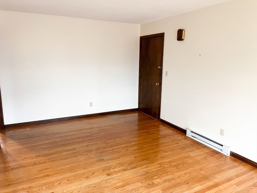 29 Mountain Road, Unit 2L Deerfield, MA 01373 - Photo 5 of 6 an empty room with wooden floor