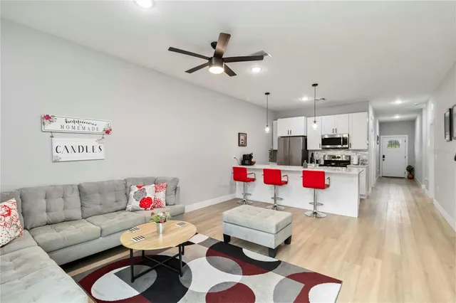 a living room with furniture and kitchen view