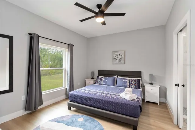 a bedroom with a large bed and a window