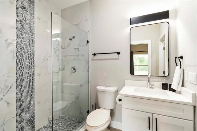 a bathroom with a toilet sink and shower