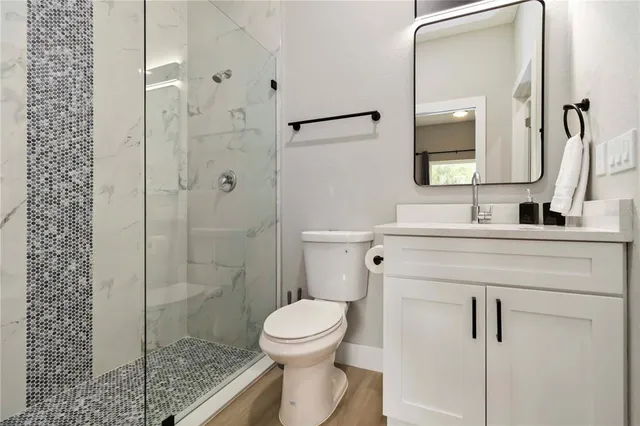 a bathroom with a toilet sink and shower
