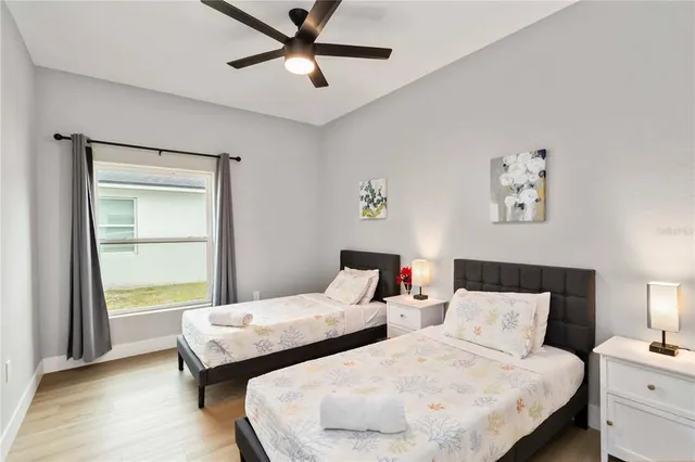 a bedroom with two beds and a window