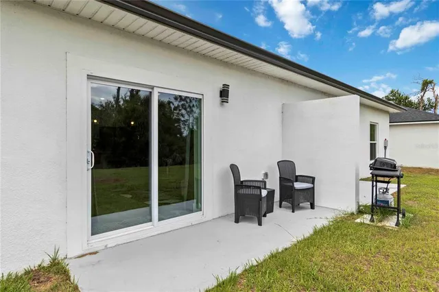a patio with table and chairs