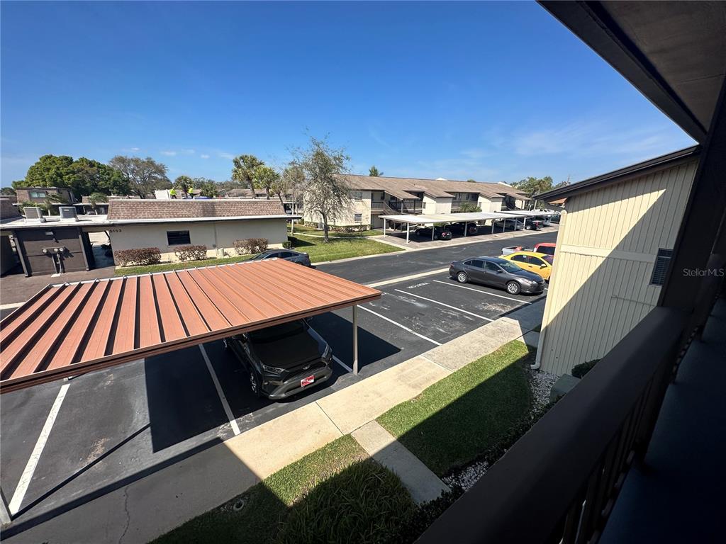 5154 Turquoise Lane, Unit 206 New Port Richey, FL 34652 - Photo 17 of 54 a view of a balcony with two chairs and a barbeque