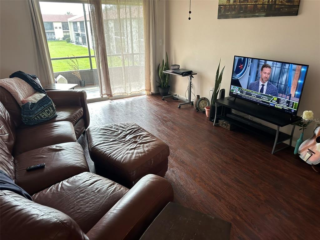5154 Turquoise Lane, Unit 206 New Port Richey, FL 34652 - Photo 29 of 54 a living room with furniture a flat screen tv and a couch