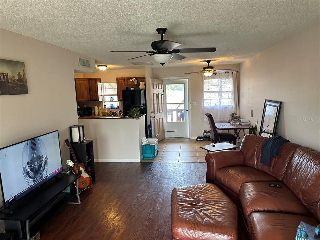 5154 Turquoise Lane, Unit 206 New Port Richey, FL 34652 - Photo 37 of 54 a living room with furniture and a wooden floor