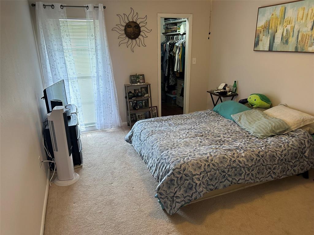 5154 Turquoise Lane, Unit 206 New Port Richey, FL 34652 - Photo 46 of 54 a bed sitting in a bedroom next to a window