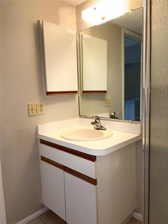 26485 Rampart Boulevard, Unit D1 Punta Gorda, FL 33983 - Photo 18 of 29 a bathroom with a sink and a mirror