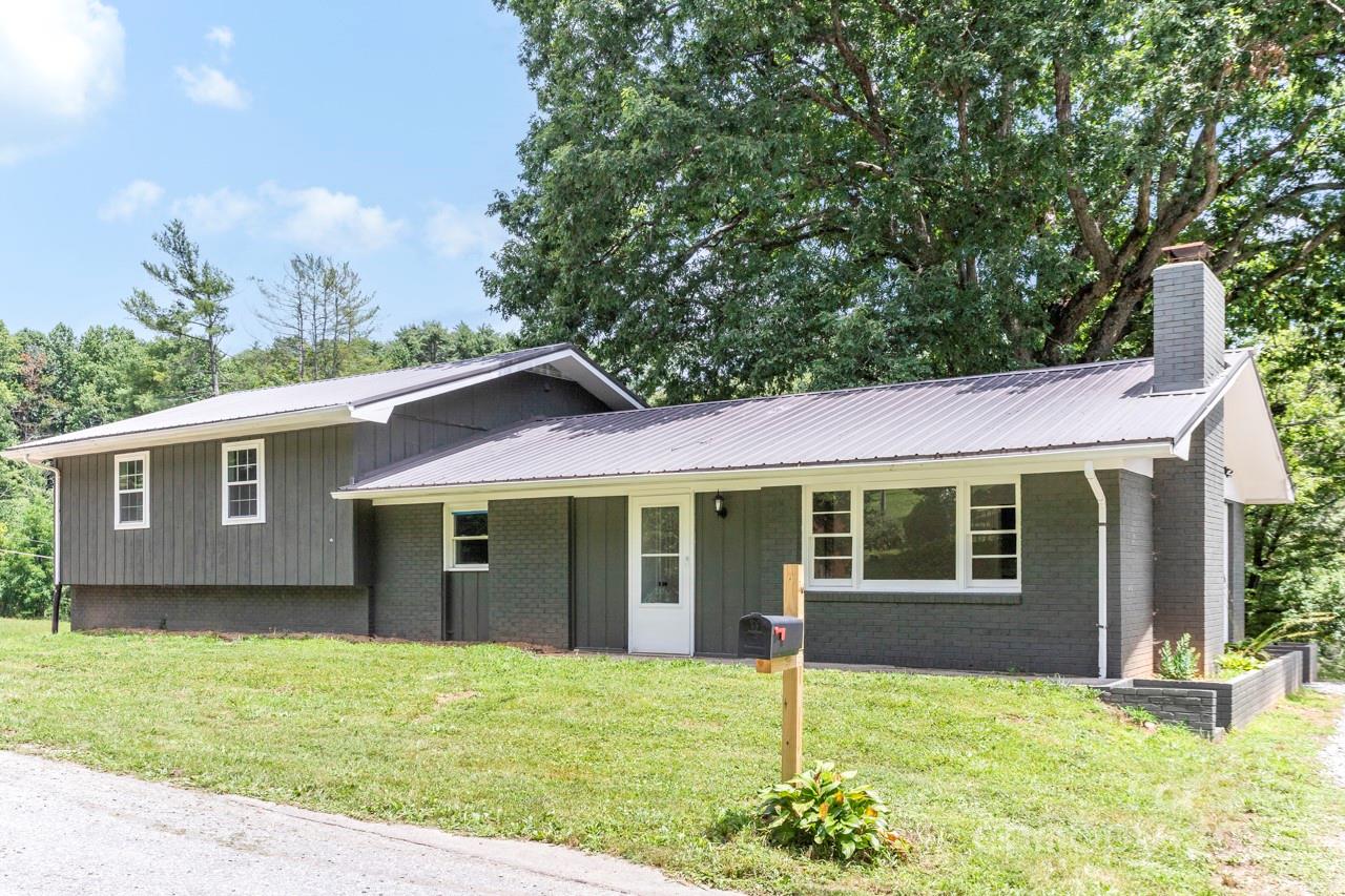 76 Trent Road Brevard, NC 28712 - Photo 3 of 31 a house view with a garden space
