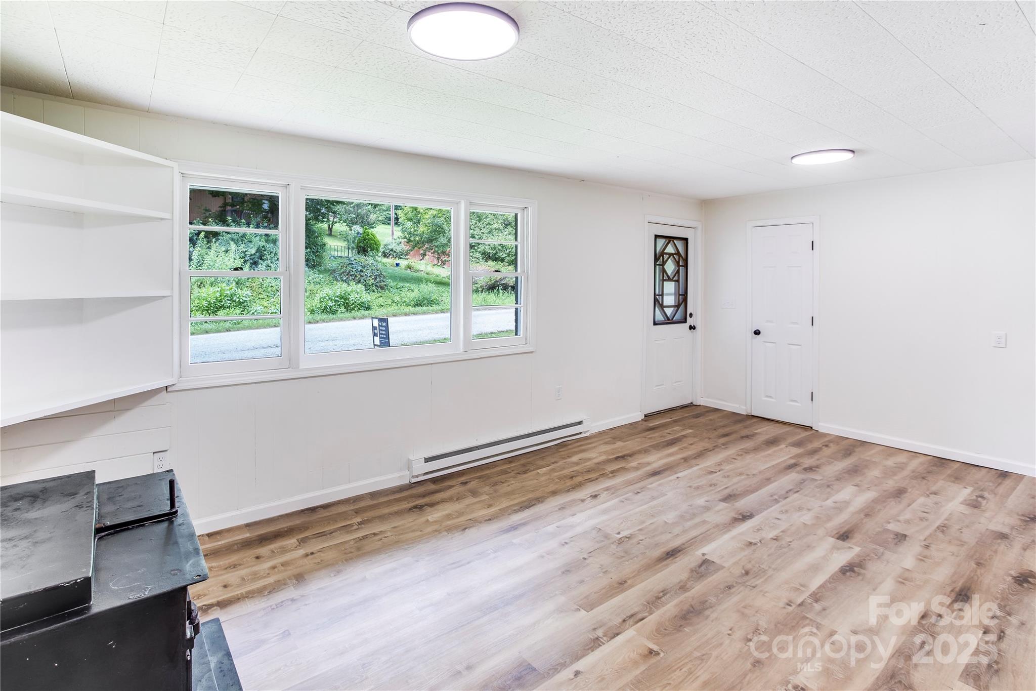 76 Trent Road Brevard, NC 28712 - Photo 9 of 31 a view of empty room with wooden floor and fan