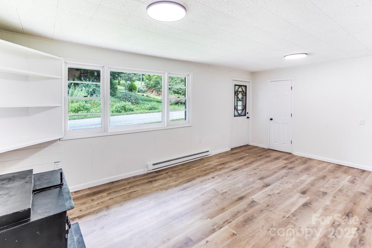 76 Trent Road Brevard, NC 28712 - Photo 10 of 31 a view of empty room with wooden floor and fan