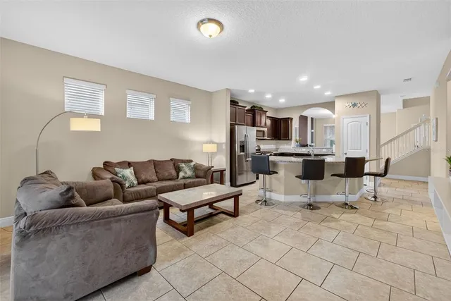 a living room with furniture and kitchen view