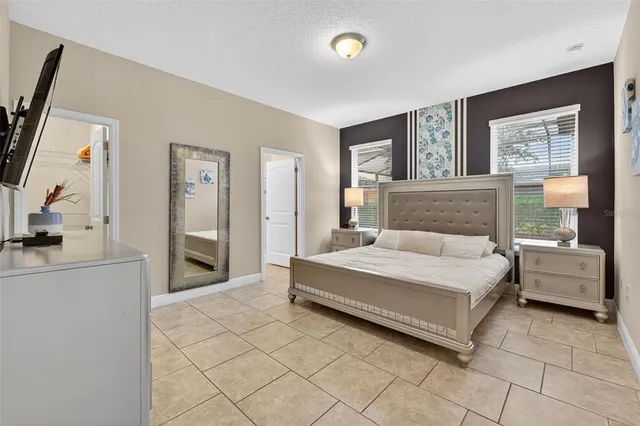 a spacious bedroom with a bed and a couch