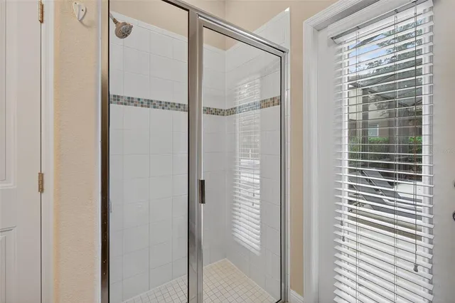 a bathroom with a glass shower door