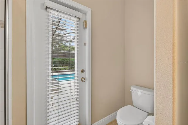 a white toilet sitting next to a shower