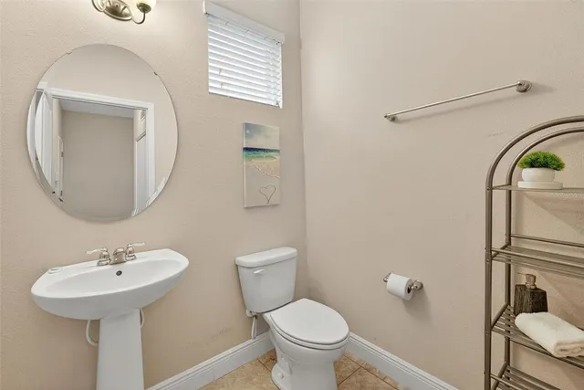 a bathroom with a sink toilet and a mirror