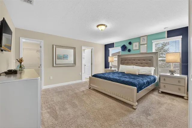 a bedroom with a large bed and a window