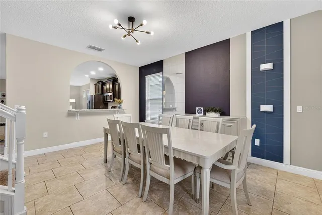 a view of a dining room with furniture and chandelier