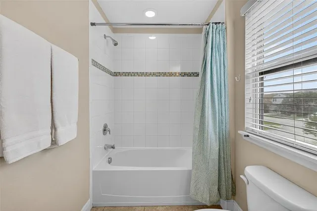 a bathroom with a shower and a toilet