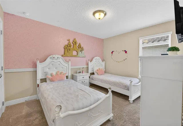 a bedroom with two beds and painted walls