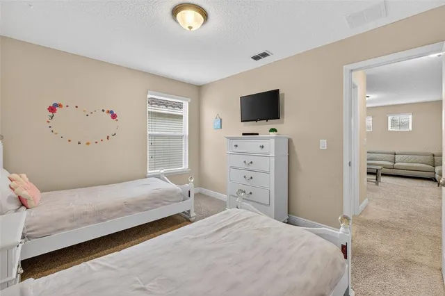 a bedroom with a bed and flat screen tv