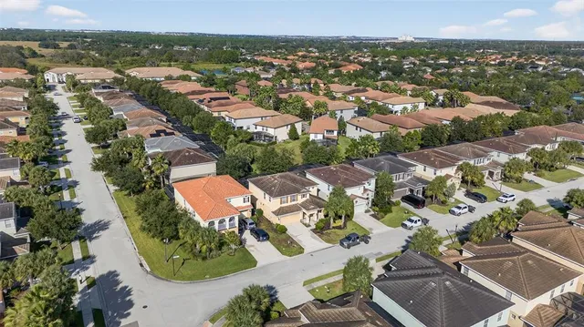 an aerial view of residential houses with outdoor space