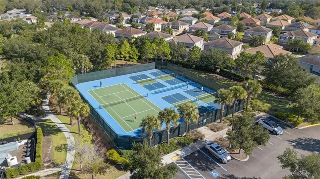 an aerial view of a residential houses with yard