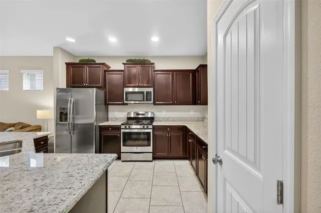 a kitchen with stainless steel appliances granite countertop a refrigerator stove and oven