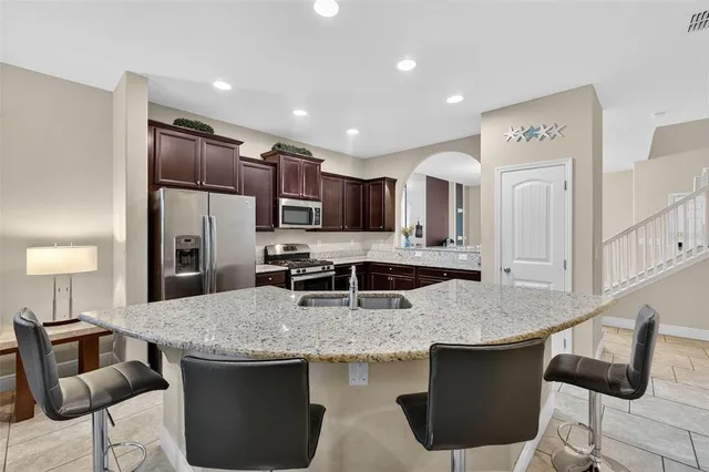 a kitchen with granite countertop kitchen island a stove and a sink