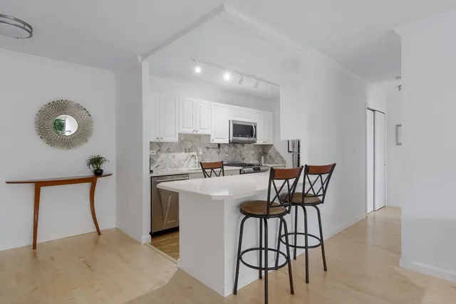 a view of kitchen with furniture and wooden floor