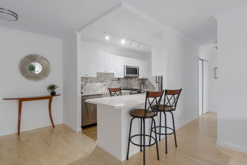 6 Whittier Place, Unit 7E Boston, MA 02114 - Photo 13 of 33 a view of kitchen with furniture and wooden floor