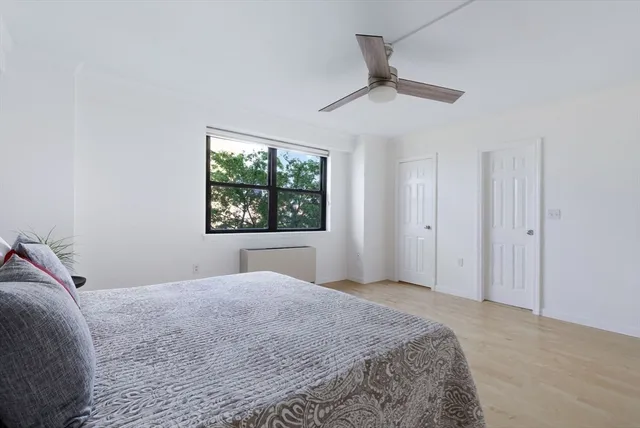 a bedroom with a large bed and a window