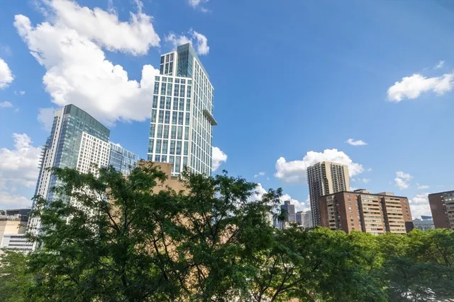 a front view of a multi story residential apartment building with a yard