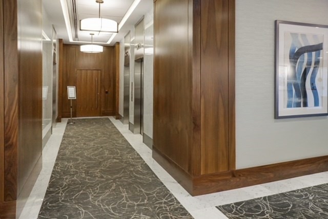 6 Whittier Place, Unit 7E Boston, MA 02114 - Photo 29 of 33 a view of a hallway with wooden floor