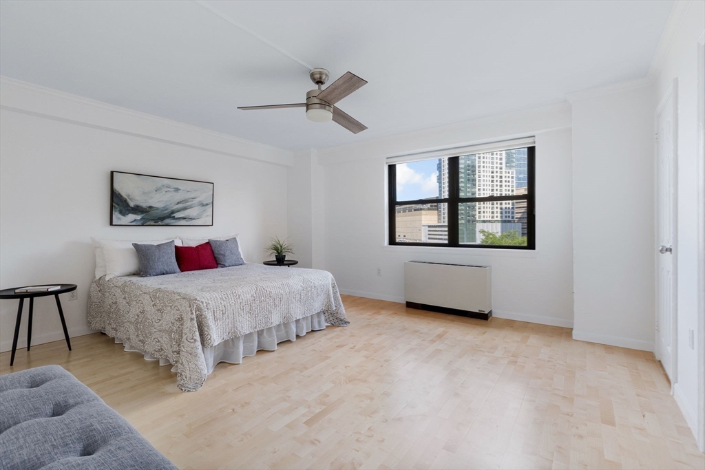 6 Whittier Place, Unit 7E Boston, MA 02114 - Photo 5 of 33 a bedroom with a bed and a window
