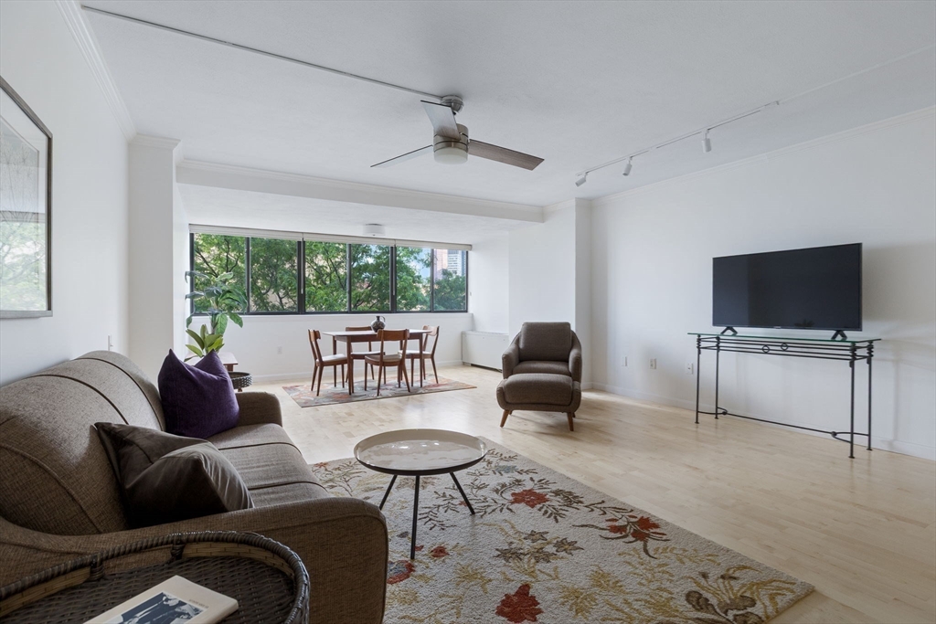 6 Whittier Place, Unit 7E Boston, MA 02114 - Photo 9 of 33 a living room with furniture and a flat screen tv