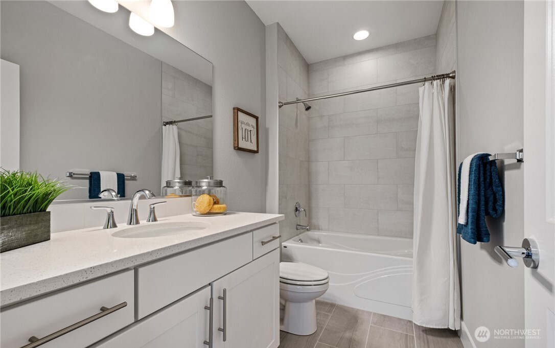 8831 27th Street East Edgewood, WA 98371 - Photo 16 of 27 a bathroom with a sink toilet and shower