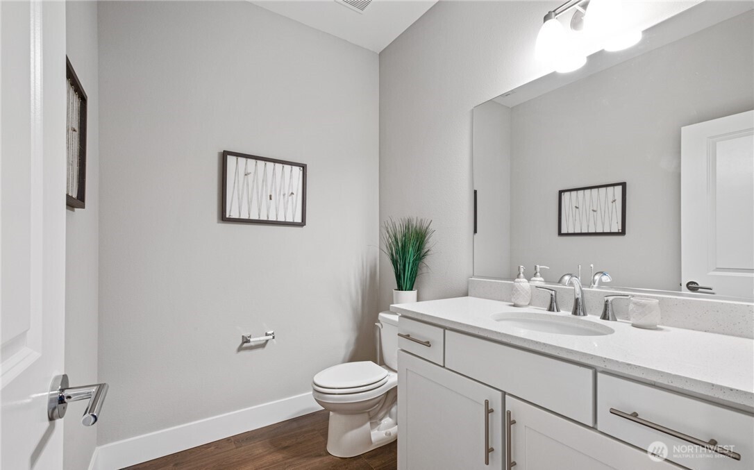 8831 27th Street East Edgewood, WA 98371 - Photo 22 of 27 a bathroom with a toilet sink and mirror
