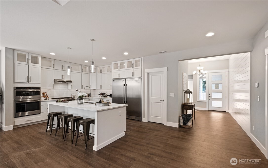 8831 27th Street East Edgewood, WA 98371 - Photo 8 of 27 a kitchen with refrigerator and cabinets