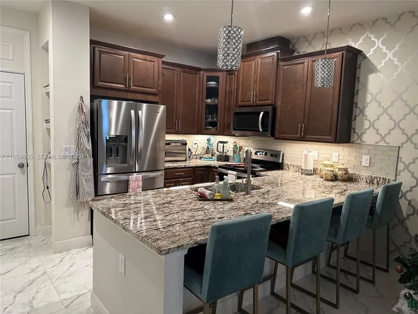 a living room with granite countertop furniture and a large mirror
