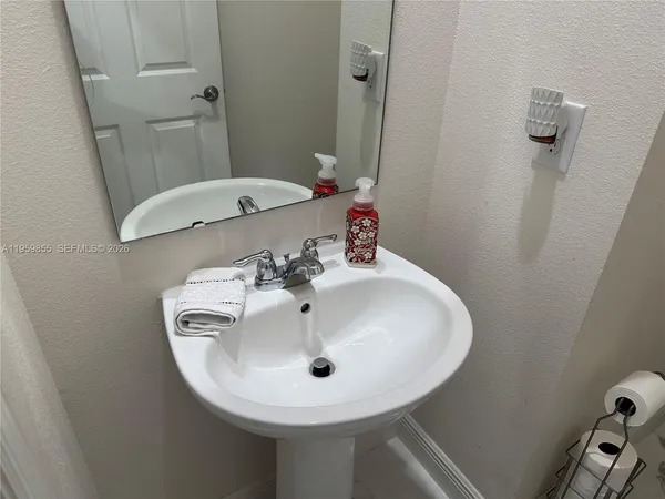 a bathroom with a toilet a sink and mirror