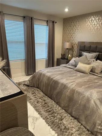 a living room with a bed and a television