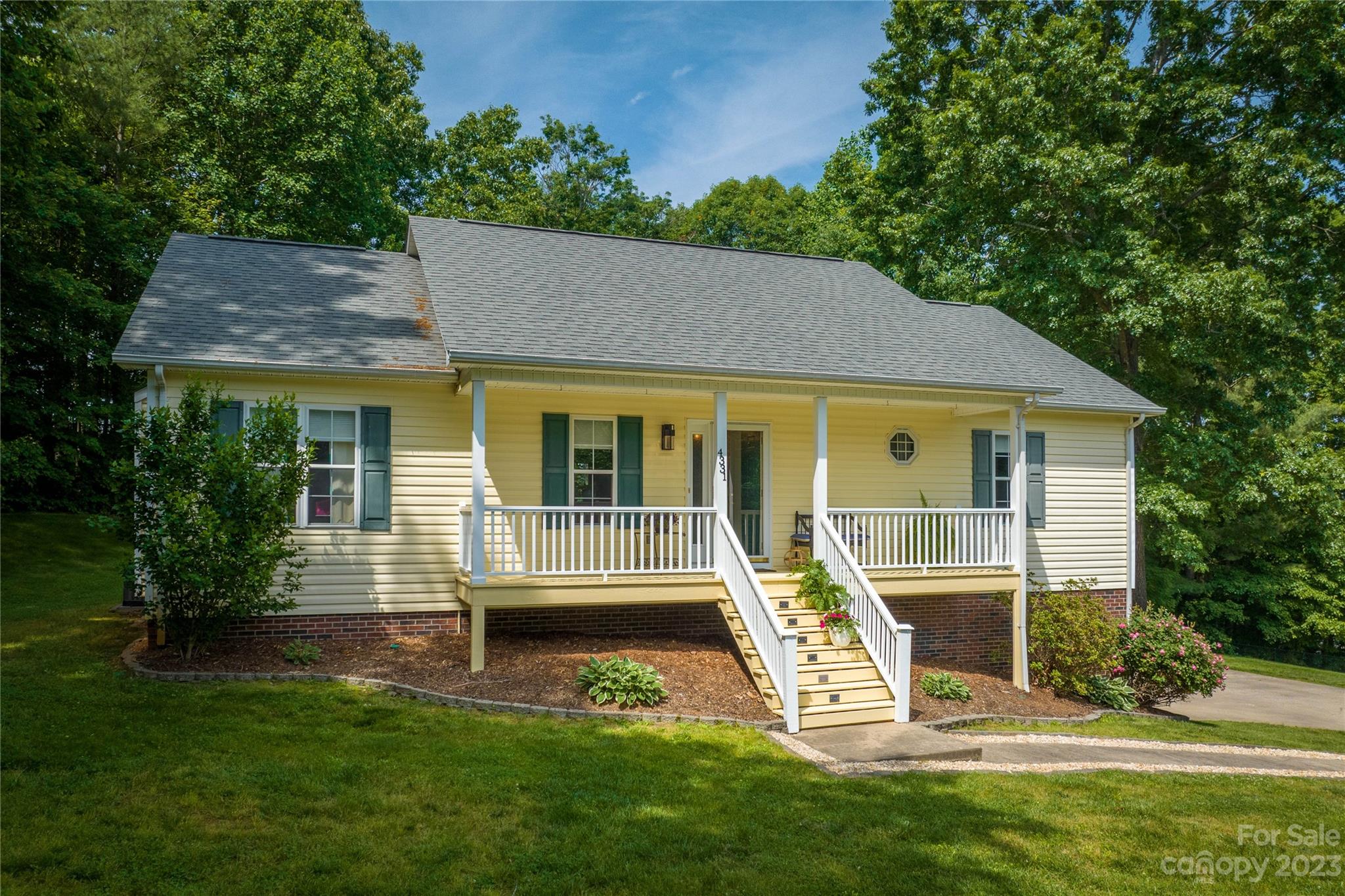 a view of house with a yard